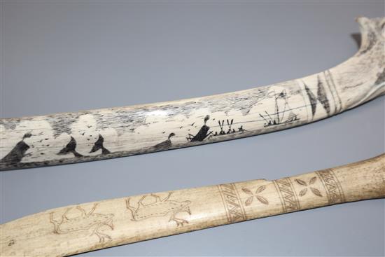 An eskimo scrimshaw elk bone and a similar paper knife,